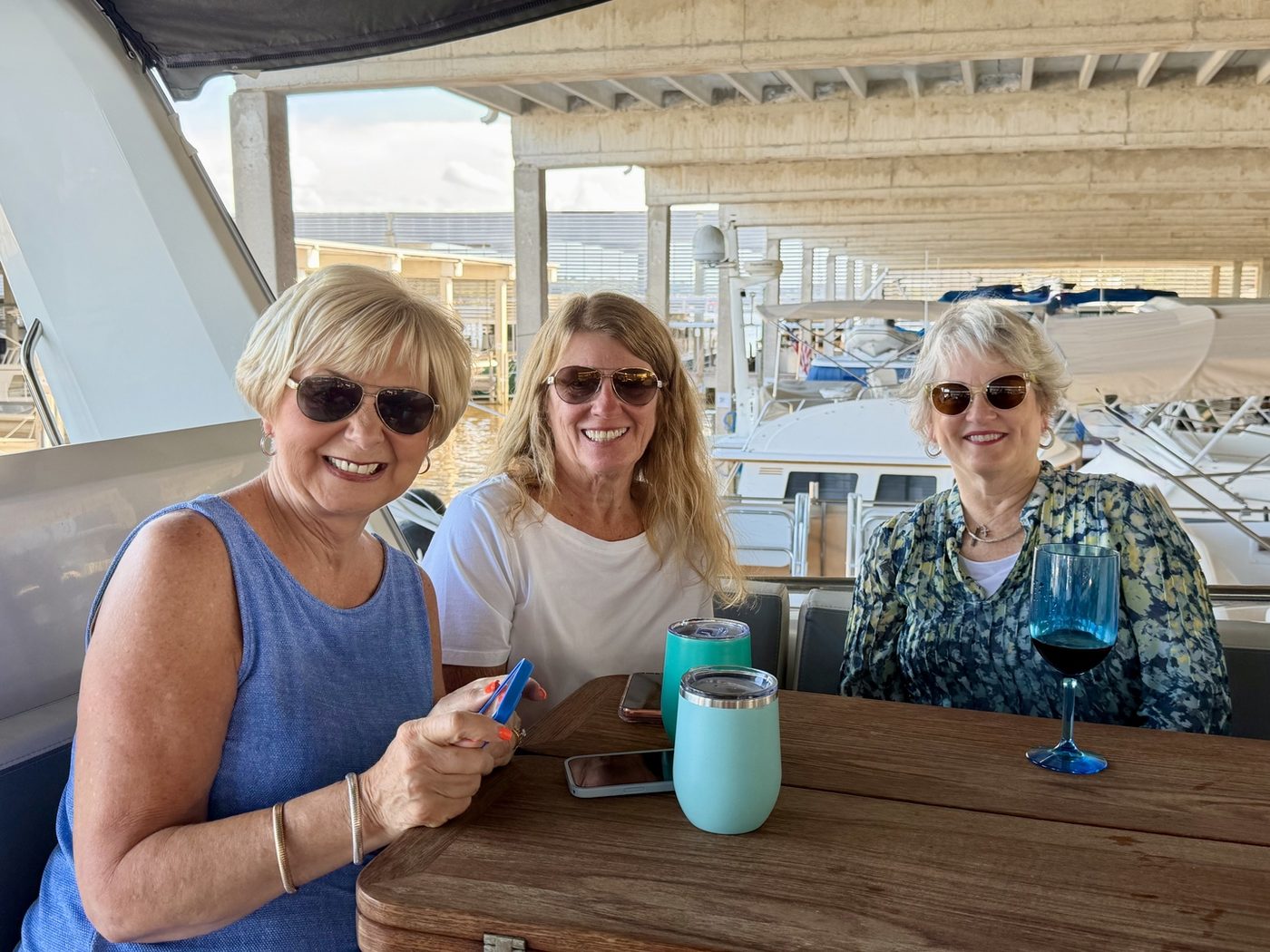 Three guests posing on the marina dock before boarding